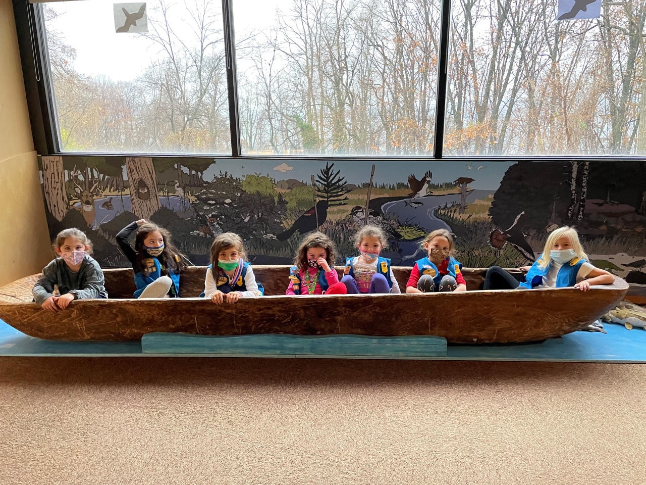 girl scouts investigating a dugout canoe